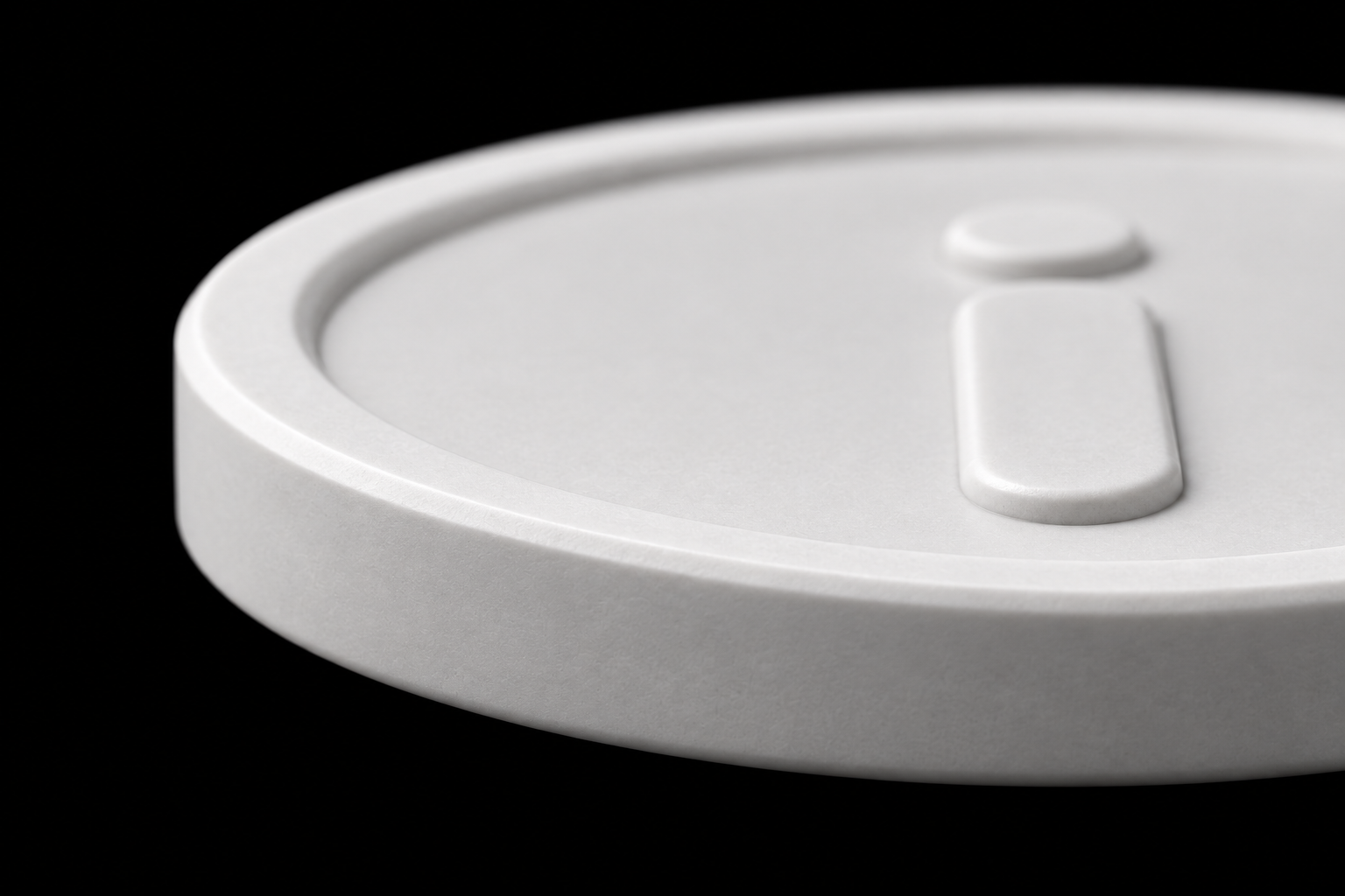 Close-up of iCoin’s neutral white matte ceramic and shallow rounded relief